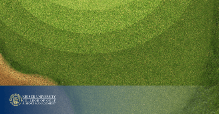 Top-down view of a golf green and sand trap with Keiser University College of Golf logo.